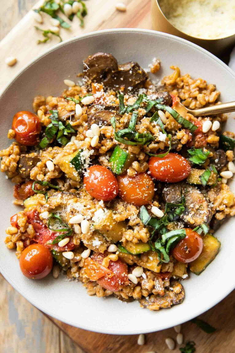 Farro with Blistered Tomatoes & Pesto in a large bowl with a fork.