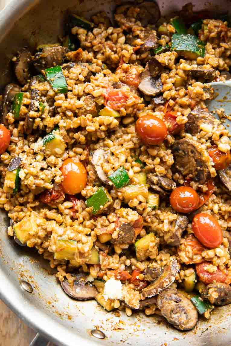Farro with Blistered Tomatoes & Pesto cooked in a pan.