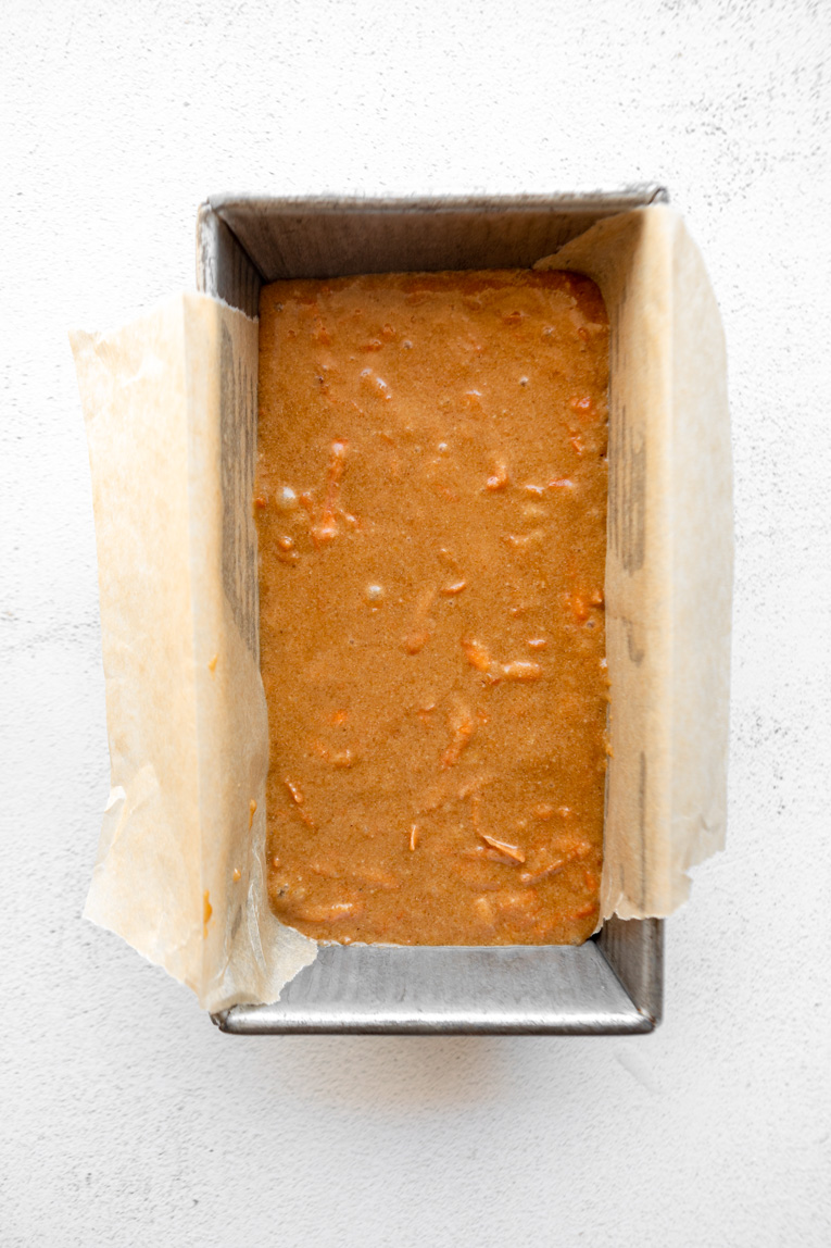 Gluten-free carrot cake batter poured into a loaf pan.