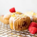 Across photo of a Gluten-Free Lemon Raspberry Muffin on a cooling rack.