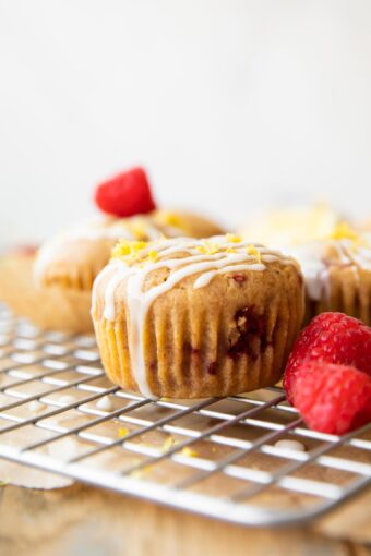 Across photo of a Gluten-Free Lemon Raspberry Muffin on a cooling rack.
