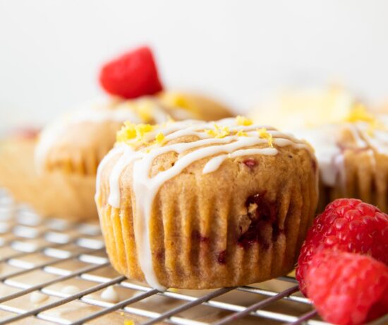 Across photo of a Gluten-Free Lemon Raspberry Muffin on a cooling rack.