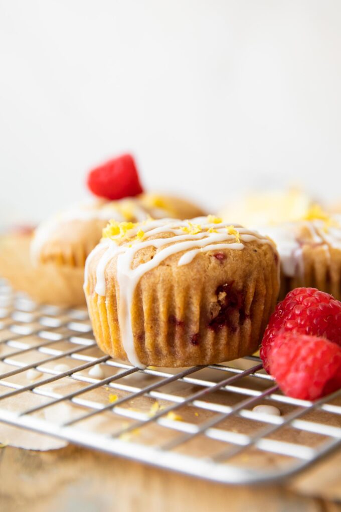 Across photo of a Gluten-Free Lemon Raspberry Muffin on a cooling rack.