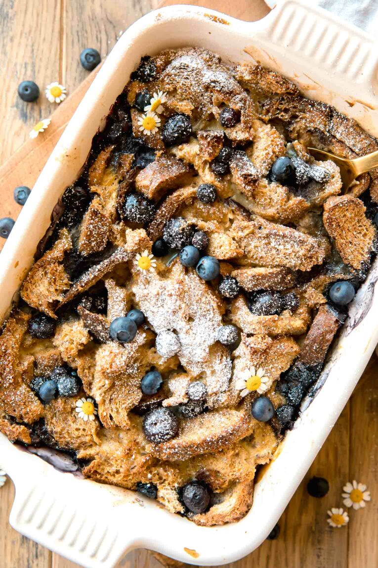 Top photo of Healthy Blueberry French Toast Casserole with a serving spoon.