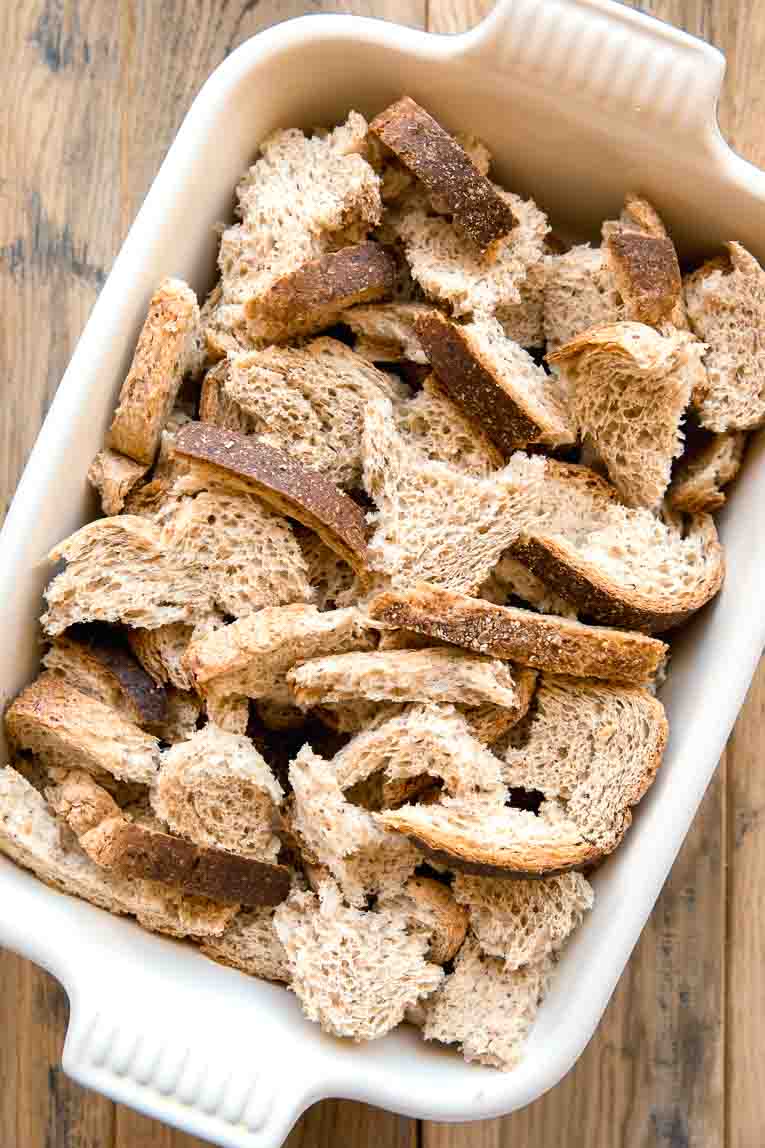 Bread torn into a casserole dish.