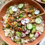 Korean Beef Bowls recipe with radishes and cucumbers.