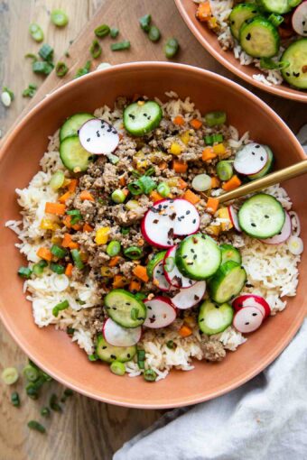 Korean Beef Bowls recipe with radishes and cucumbers.