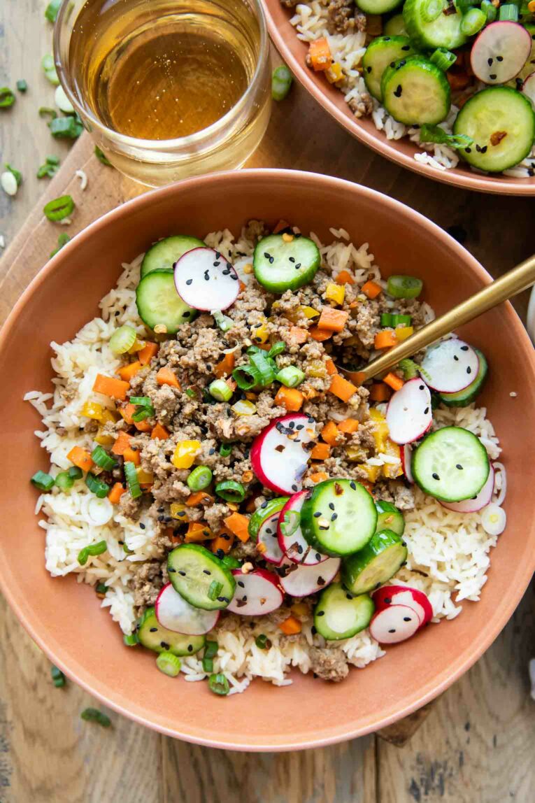 Korean Beef Bowls with rice, ground beef, vegetables, and sesame seeds.