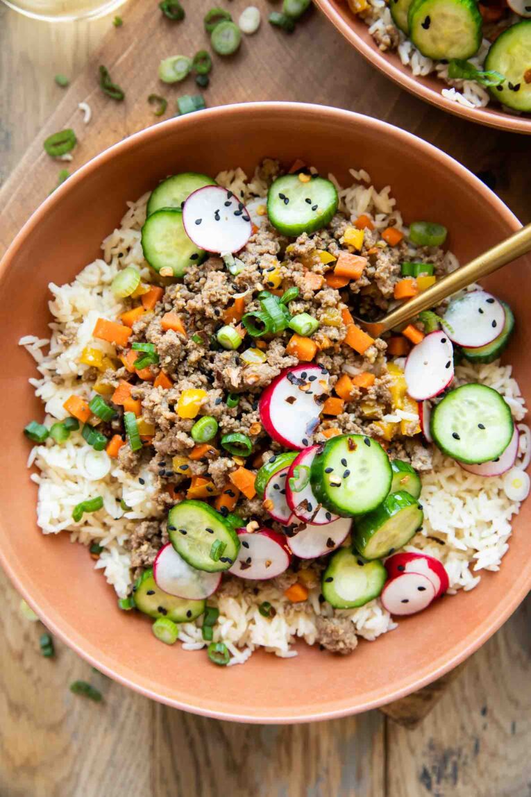 Korean Beef Bowl recipe with a fork and green onions on top.