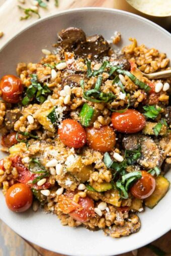 Farro with Blistered Tomatoes & Pesto in a large bowl with a fork.