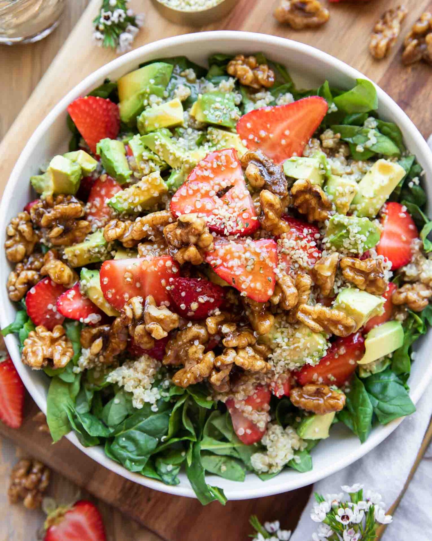 Avocado Strawberry Spinach Salad recipe top shot in a bowl.