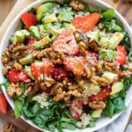 Avocado Strawberry Spinach Salad recipe top shot in a bowl.