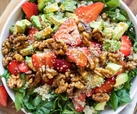Avocado Strawberry Spinach Salad recipe top shot in a bowl.