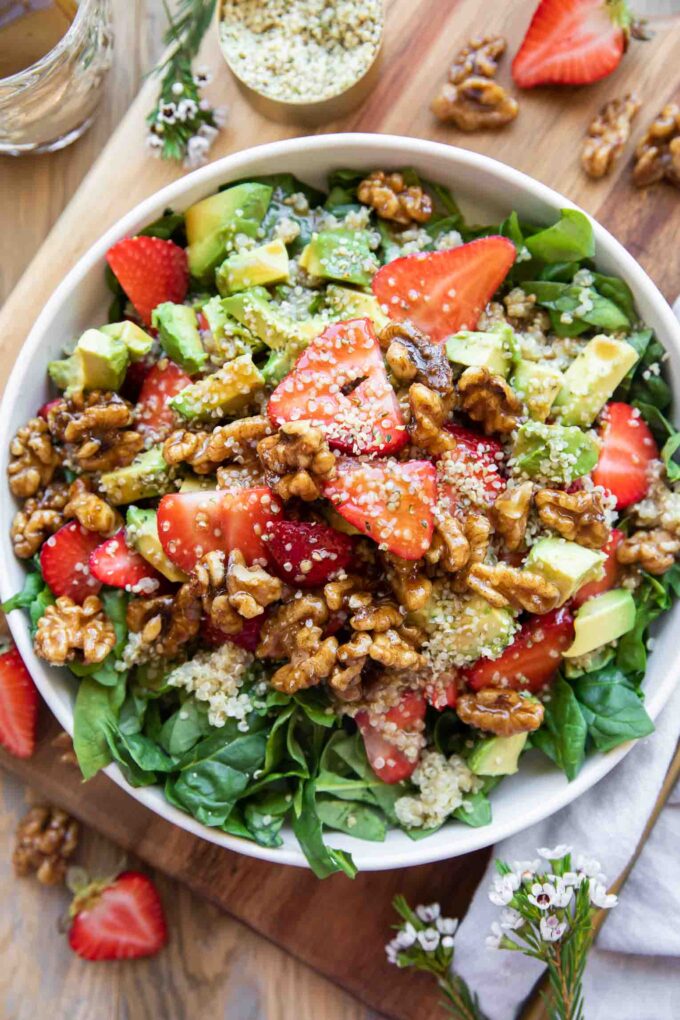 Avocado Strawberry Spinach Salad recipe top shot in a bowl.