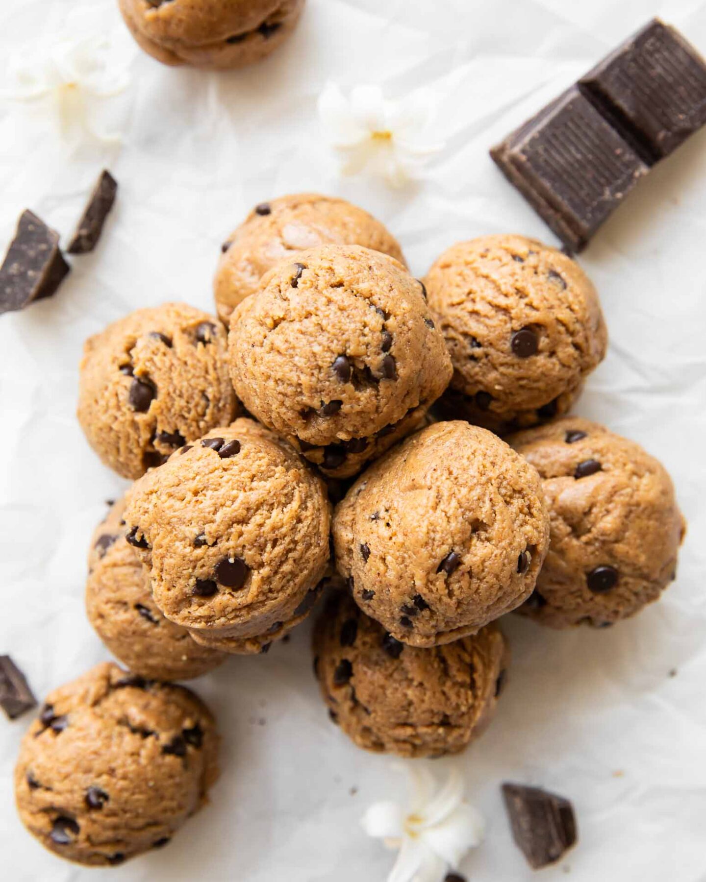 Chocolate Chip Cookie Dough Energy Bites stacked on top of each other.