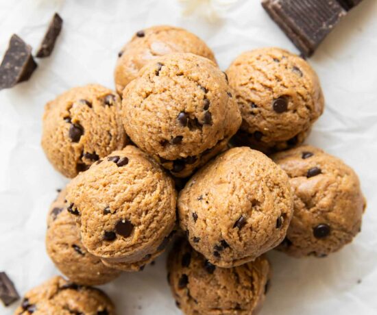 Chocolate Chip Cookie Dough Energy Bites stacked on top of each other.