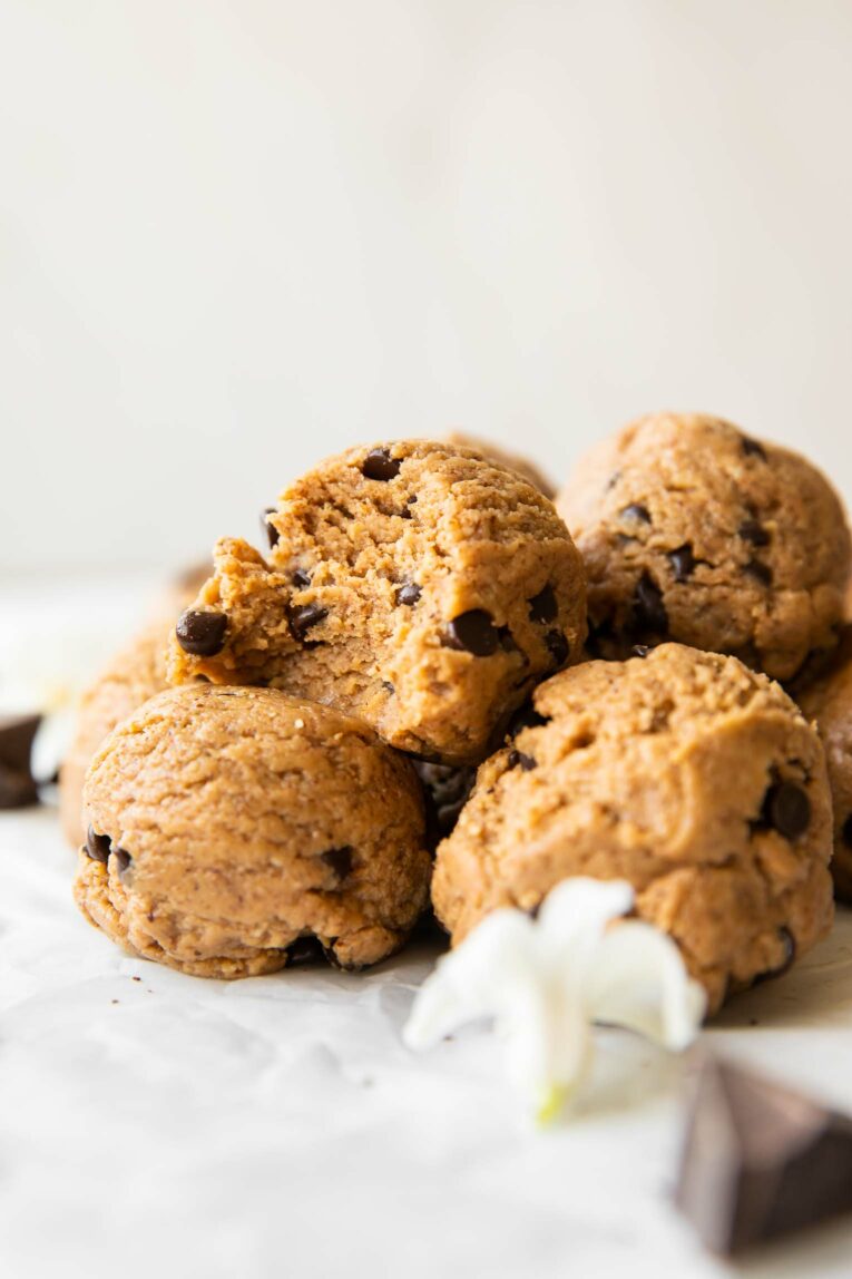 Across photo of Chocolate Chip Cookie Dough protein ball with bite taken out.