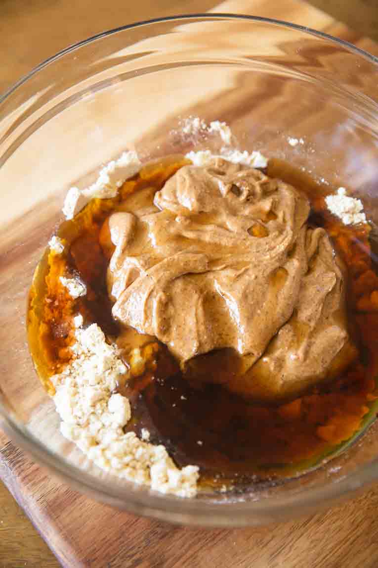 Liquid ingredients in a mixing bowl for protein bites.