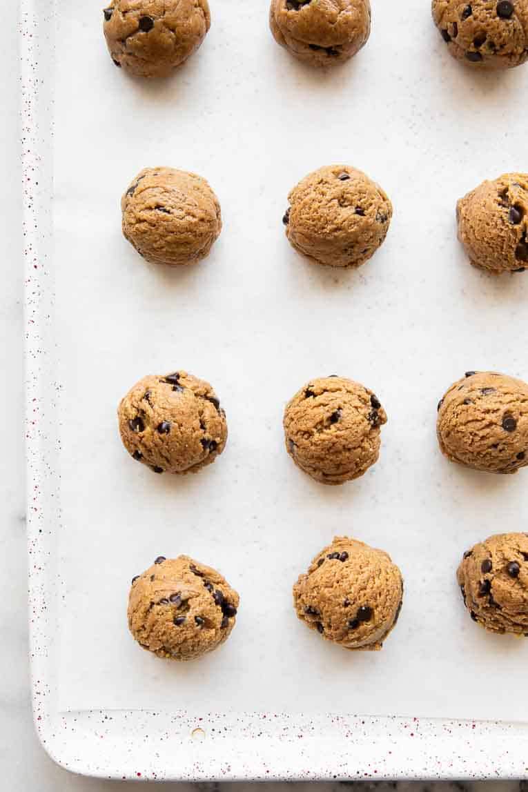 Cookie dough protein balls on a baking sheet.