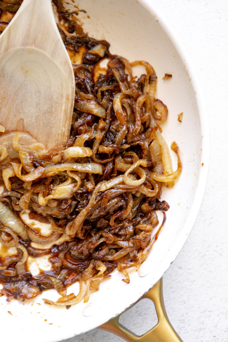 Onions being sautéed in a non-stick skillet.