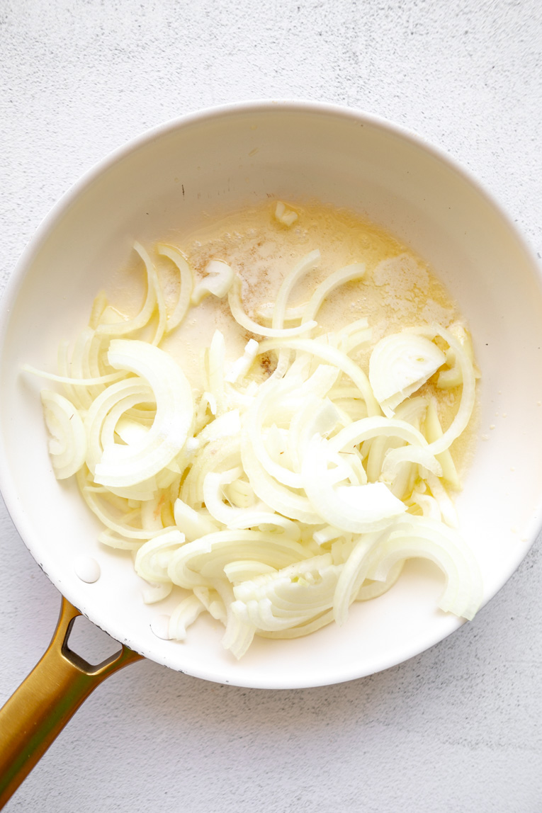 Yellow sliced onions being cooked.