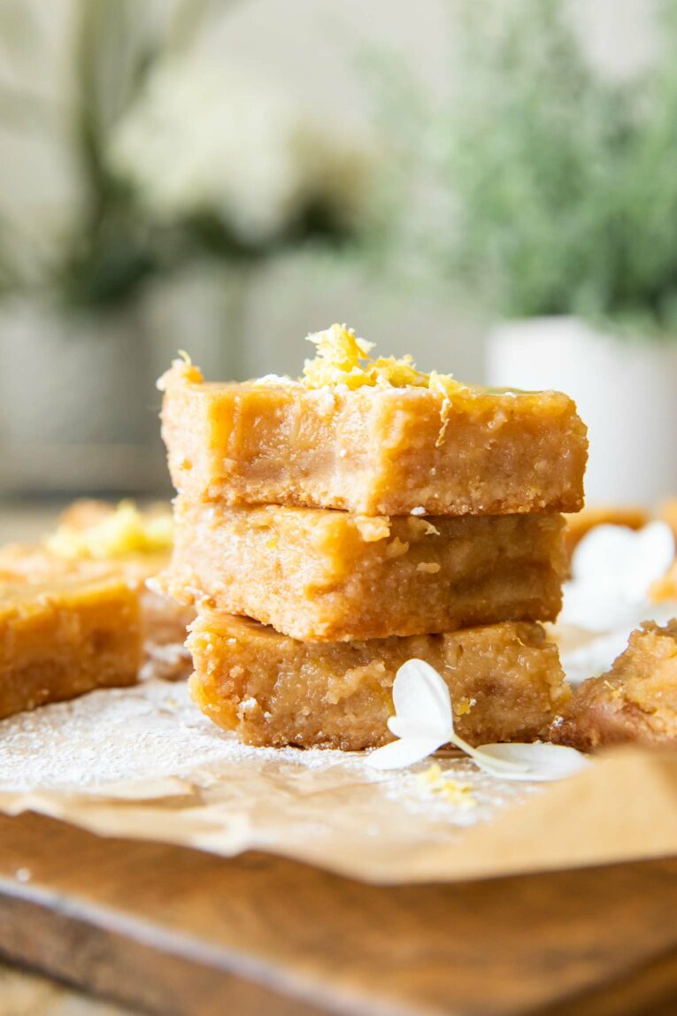 Gluten-Free Lemon Bars stacked with a bite taken out.