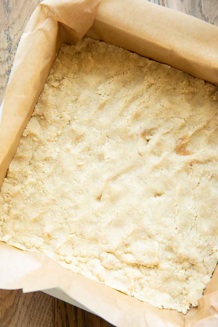 Almond flour shortbread crust pressed into baking pan.