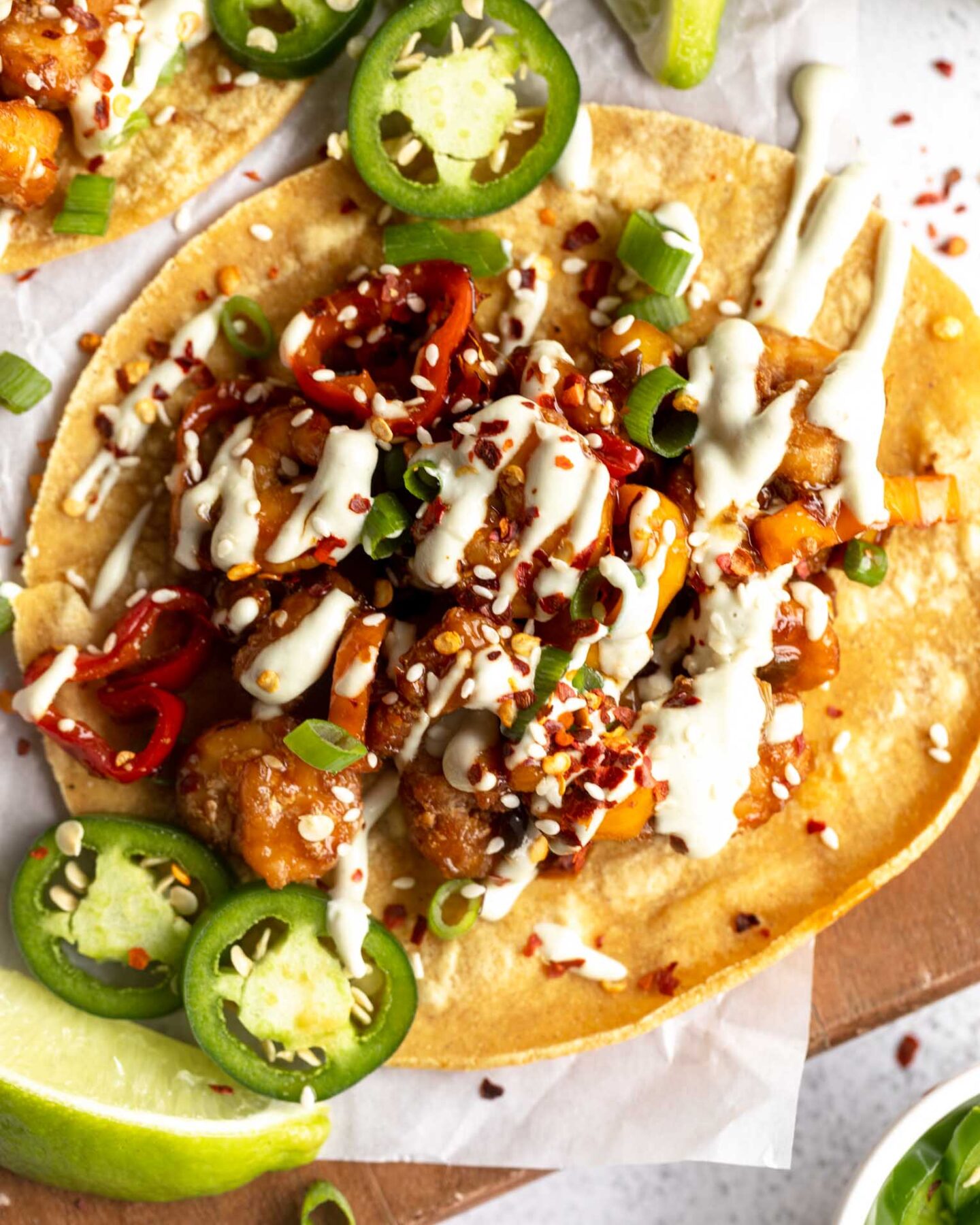 Top shot close up of Kung Pao Shrimp Tacos with Jalapeño Sauce.