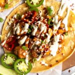 Top shot close up of Kung Pao Shrimp Tacos with Jalapeño Sauce.