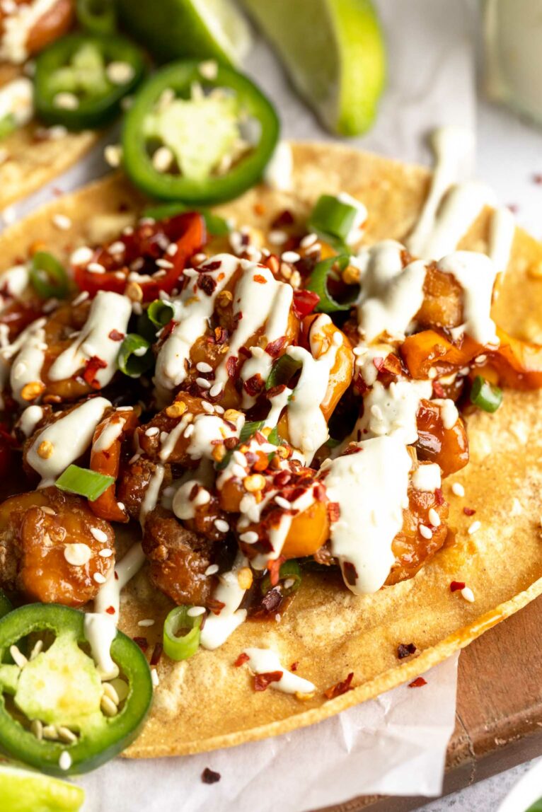 Close up angled photo of Kung Pao Shrimp Tacos with Jalapeño Sauce.