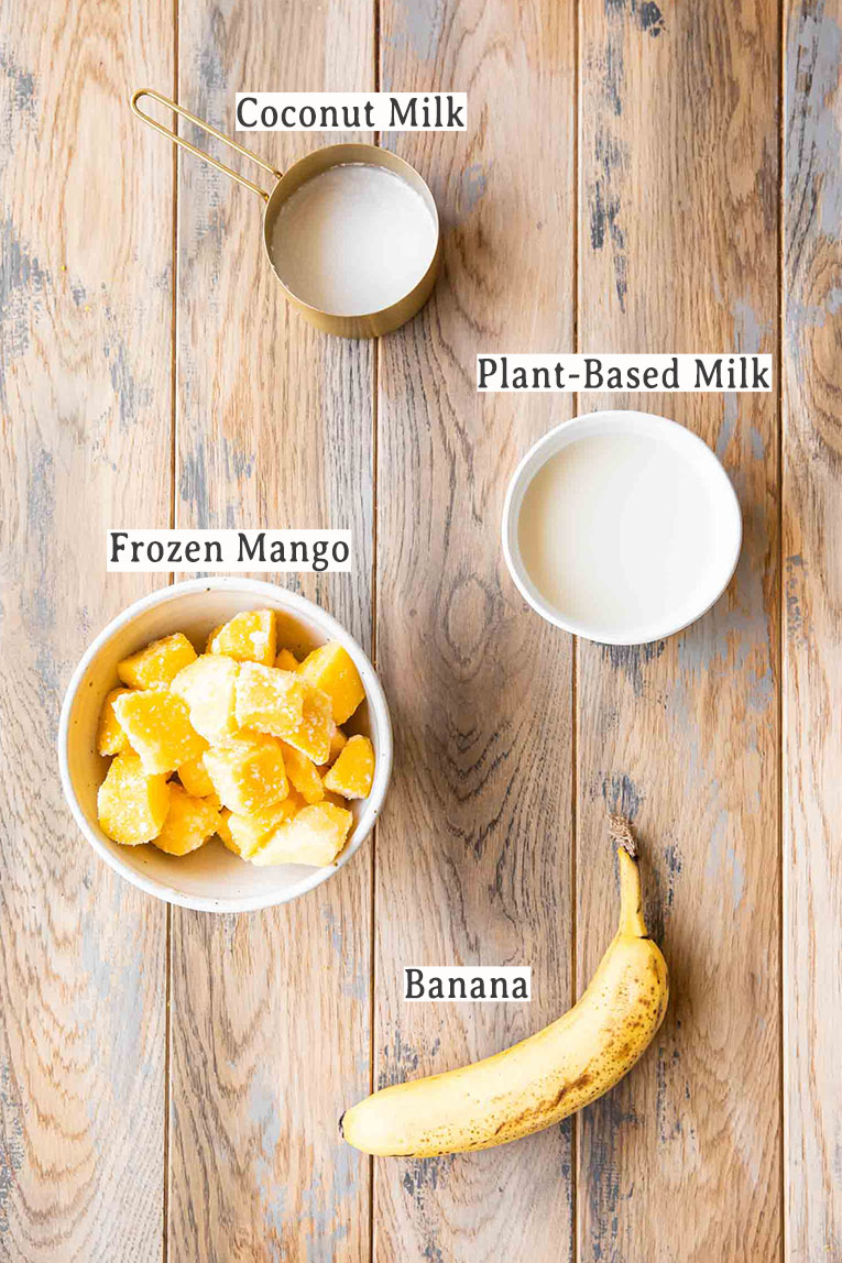 Ingredients for Mango Smoothie Recipe on a wood table.