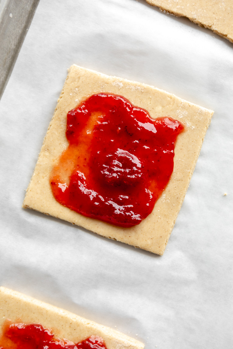 Strawberry jam filling over gluten-free pastry dough for pop tarts.