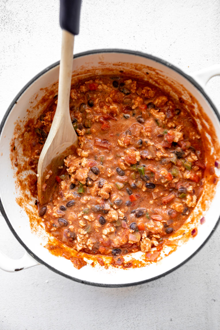 Tomato taco sauce with ground turkey and veggies in a dutch oven.