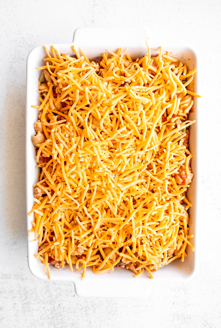 Taco pasta casserole with cheese in a casserole dish.