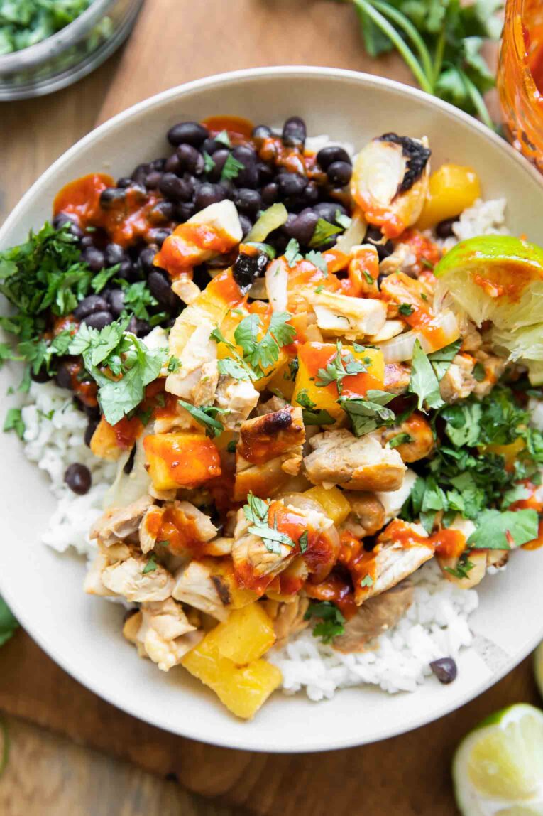 Chicken Al Pastor recipe in a bowl with rice and beans.