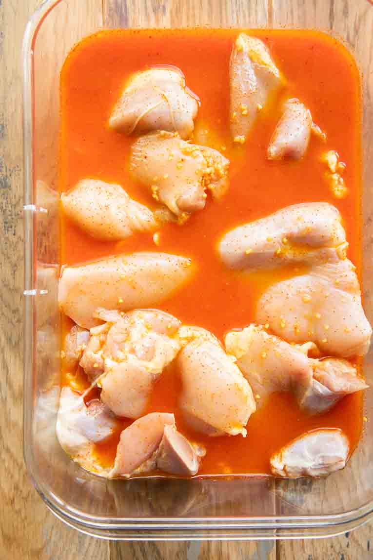 Chicken thighs marinating in al pastor sauce.
