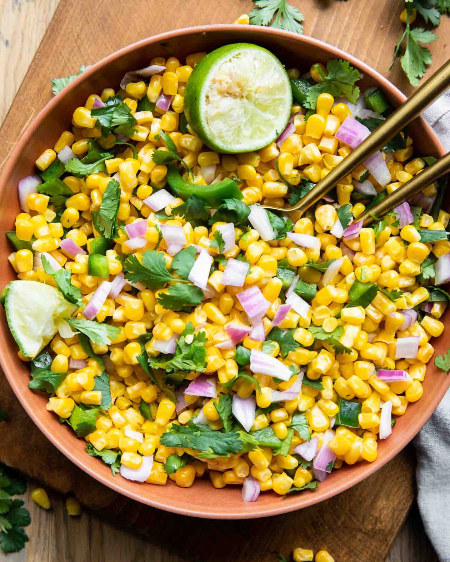 Chipotle Corn Salsa Recipe in a bowl with cilantro and lime.