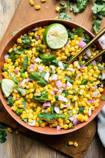 Chipotle Corn Salsa Recipe in a bowl with cilantro and lime.