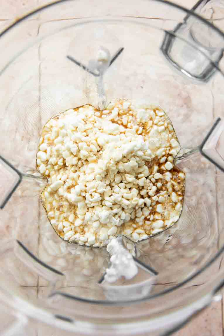 Cottage cheese, maple syrup, and vanilla in a blender.