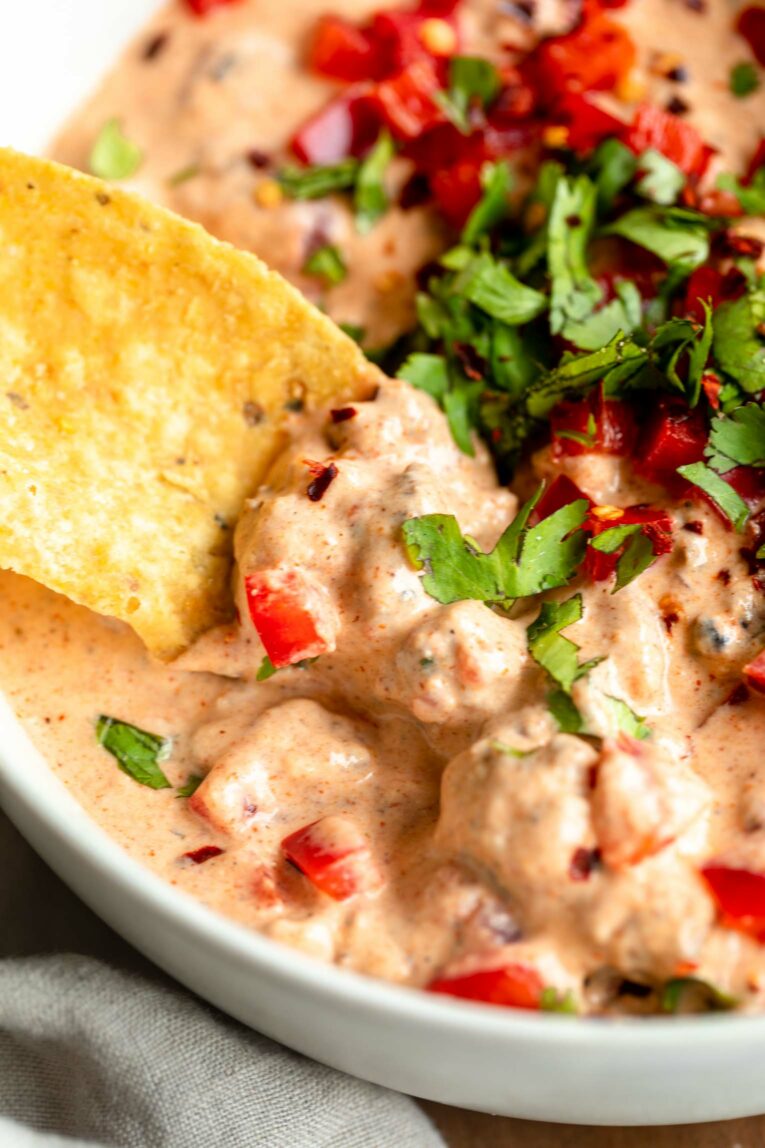 Chip being dipped into Creamy Rotel Dip.