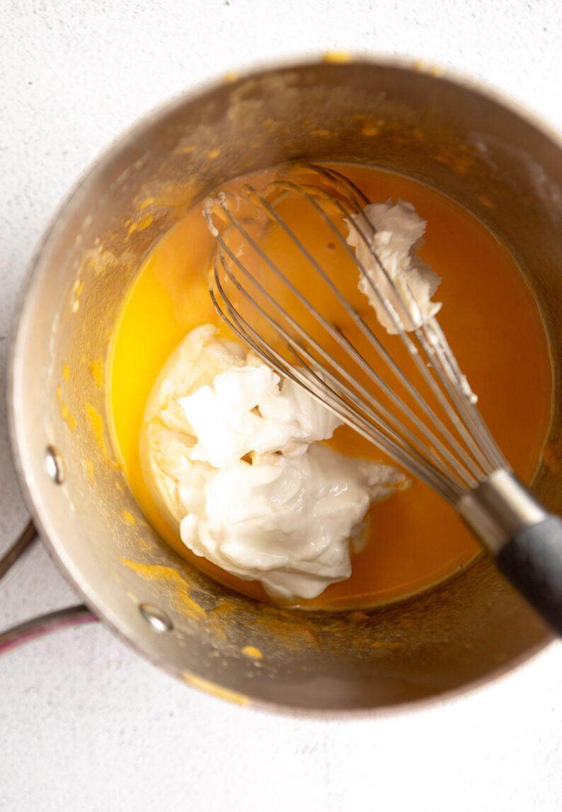 Milk, cream cheese, and yogurt in a pan with cheese.