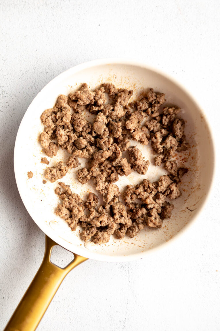 Ground beef being cooked in a skillet.