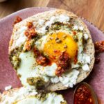 Pesto Eggs on a bagel slice.