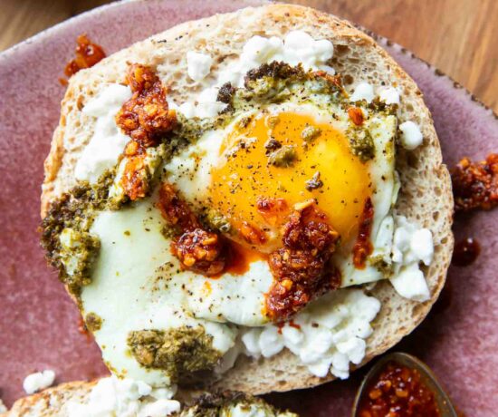 Pesto Eggs on a bagel slice.
