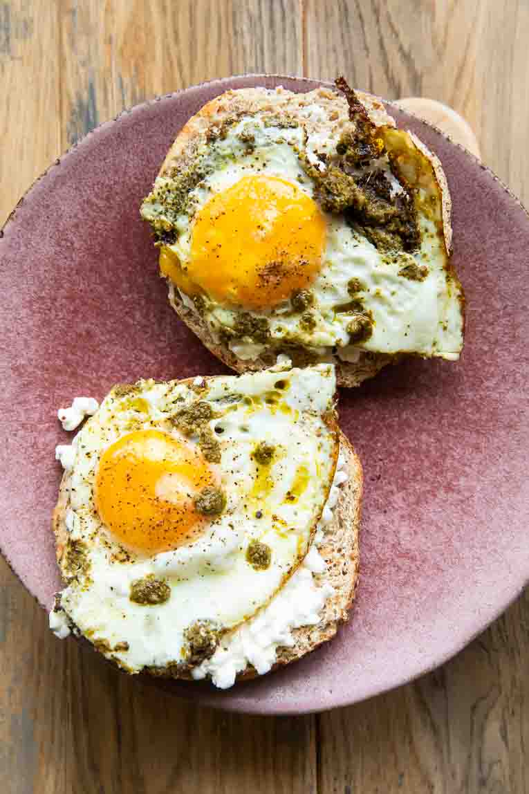 Bagels with cottage cheese and pesto eggs.