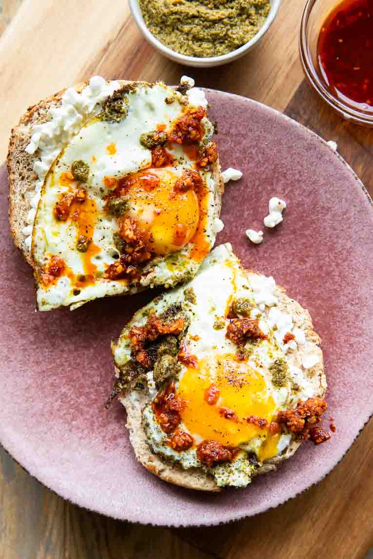 Pesto eggs on bagels with chili crunch.