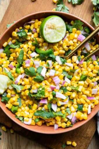 Chipotle Corn Salsa Recipe in a bowl with cilantro and lime.