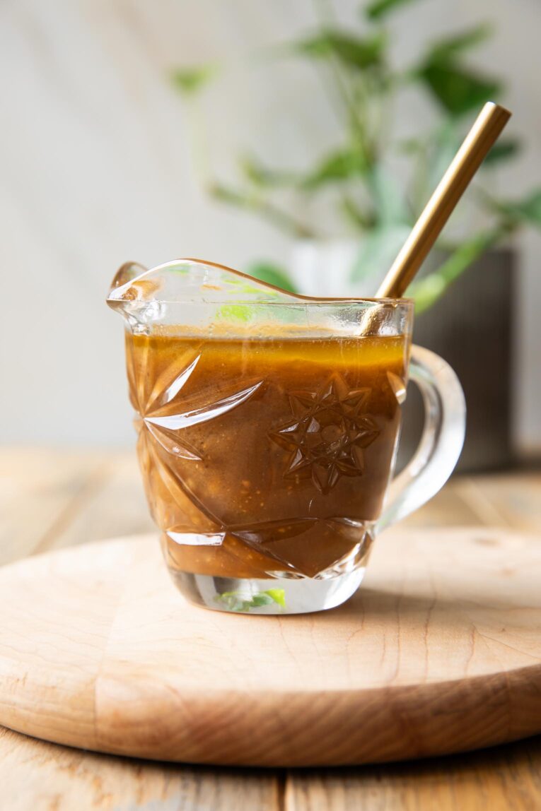 Close up of Balsamic Vinaigrette Recipe in a pouring glass.