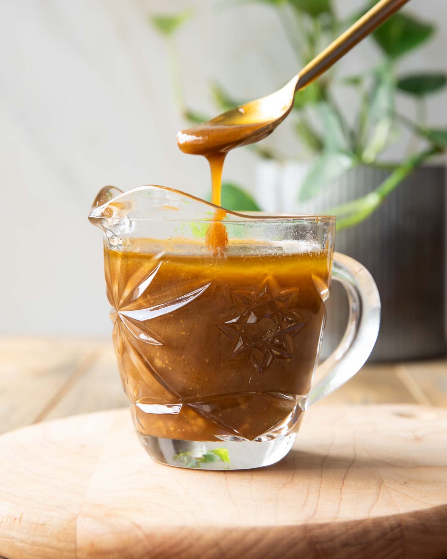 Spoon dipping into Balsamic Vinaigrette.