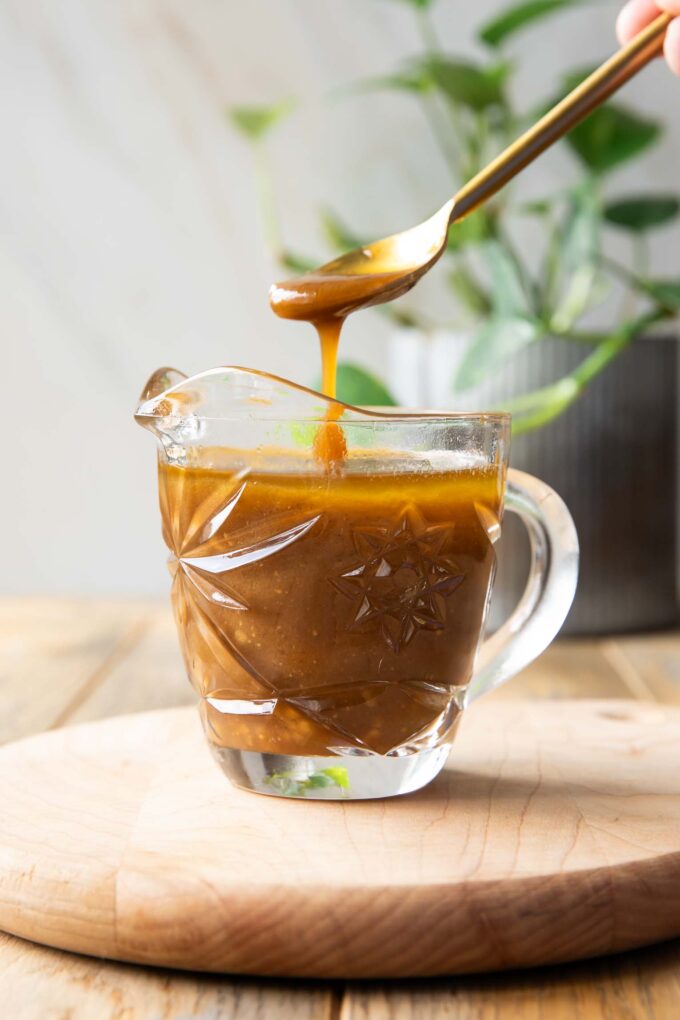 Spoon dipping into Balsamic Vinaigrette.